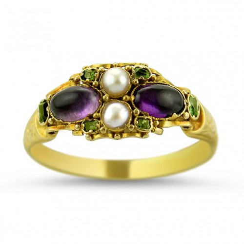 Circa 1860, from Birmingham, England, comes this Victorian 18k yellow gold ring featuring two oval amethyst cabochons and two pearls, accented by.