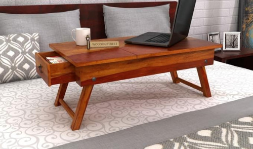 Explore the solid wood laptop table design variants available in different wood variants & finishes only @Wooden Street or get a customized one as per your desire. Visit: https://www.woodenstreet.com/laptop-table-design